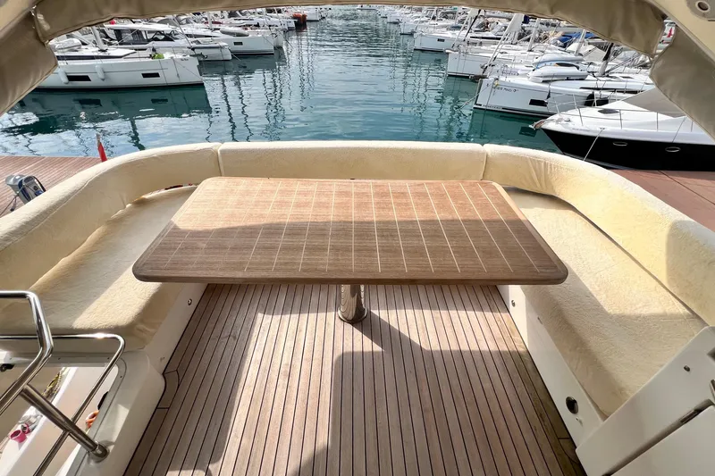 48 Navetta Yacht Photos Pics Luxury yacht Absolute NAVETTA 48, 2019 model, featuring elegant outdoor seating and table at marina.