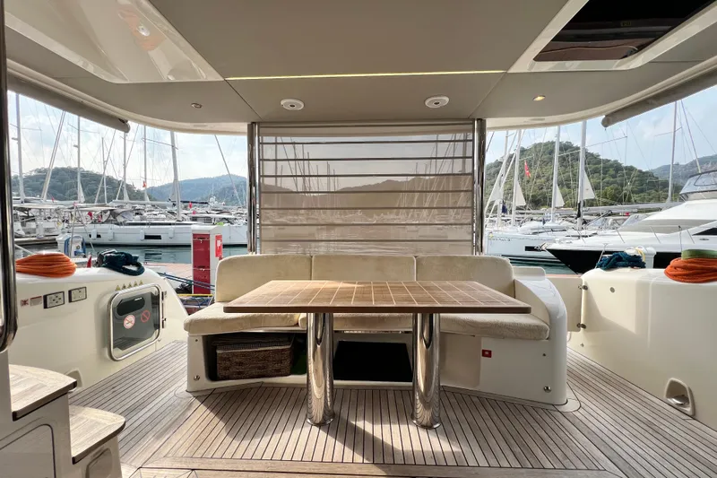 48 Navetta Yacht Photos Pics Luxurious 2019 Absolute NAVETTA 48 yacht interior with elegant seating and table, docked at marina.