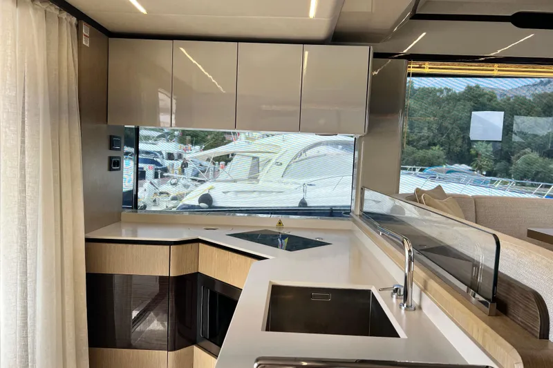 48 Navetta Yacht Photos Pics Luxurious kitchen interior of 2019 Absolute NAVETTA 48 yacht with modern design and scenic view.