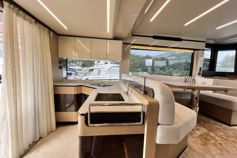 48 Navetta Yacht Photos Pics Luxurious interior of 2019 Absolute NAVETTA 48 yacht with modern kitchen and seating area.