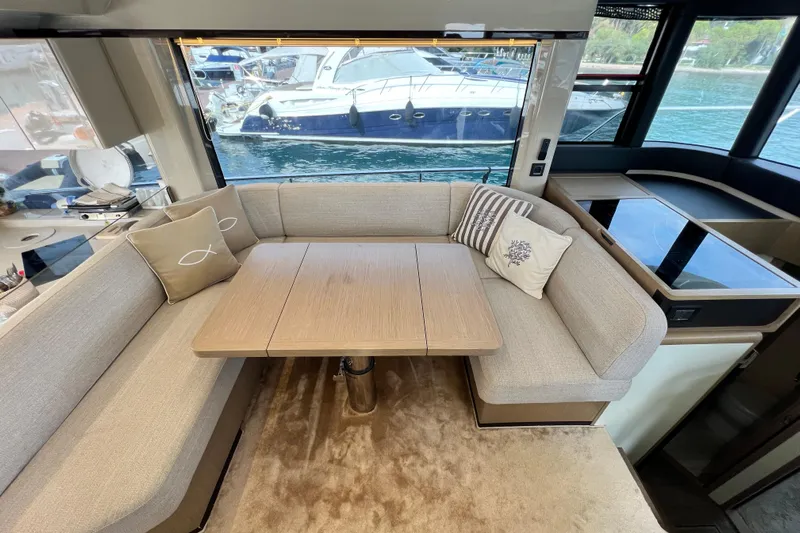 48 Navetta Yacht Photos Pics Luxurious interior of 2019 Absolute NAVETTA 48 yacht with elegant seating and table.