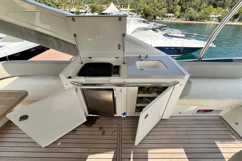 48 Navetta Yacht Photos Pics Outdoor kitchenette on 2019 Absolute NAVETTA 48 yacht with sink, grill, and storage.