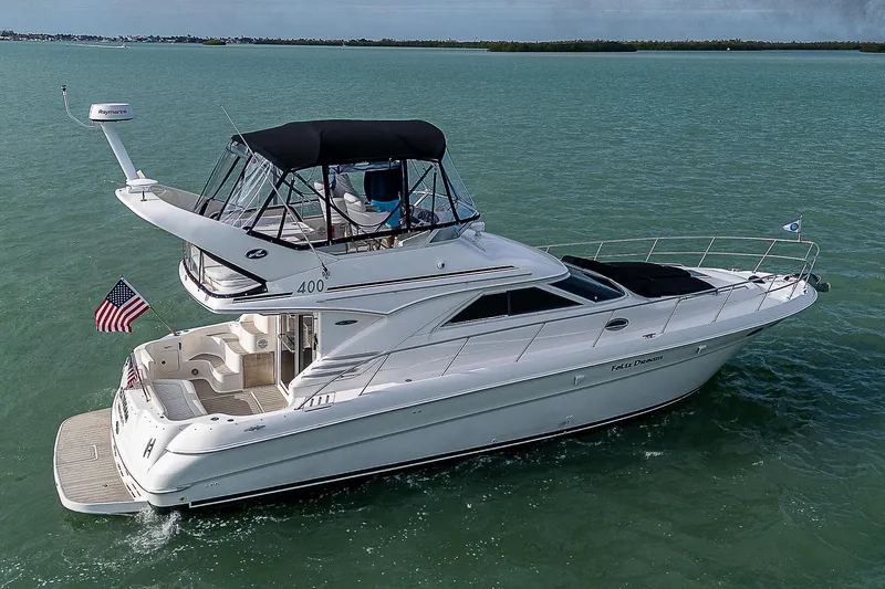 Feliz Dream Yacht Photos Pics 2001 Sea Ray 400 Sedan Bridge yacht cruising on open water.