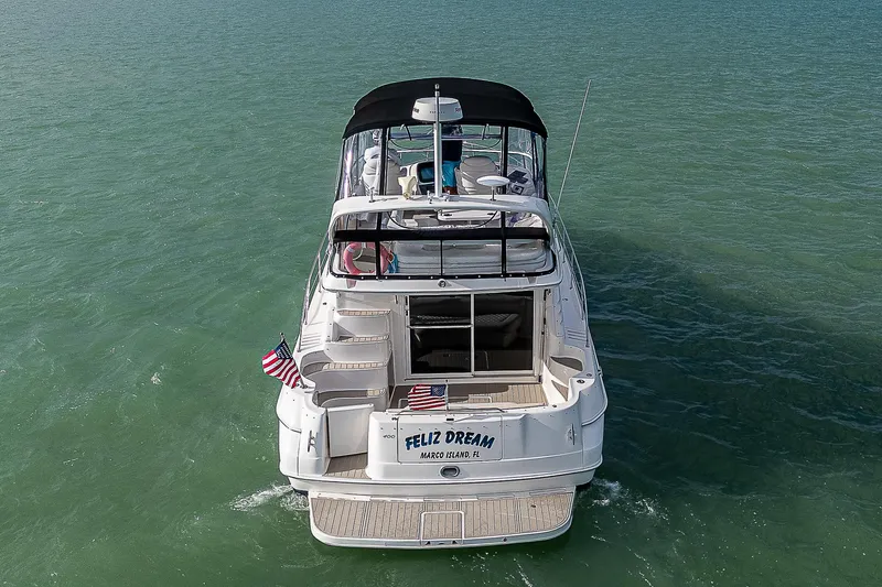 Feliz Dream Yacht Photos Pics 2001 Sea Ray 400 Sedan Bridge yacht on open water, rear view.