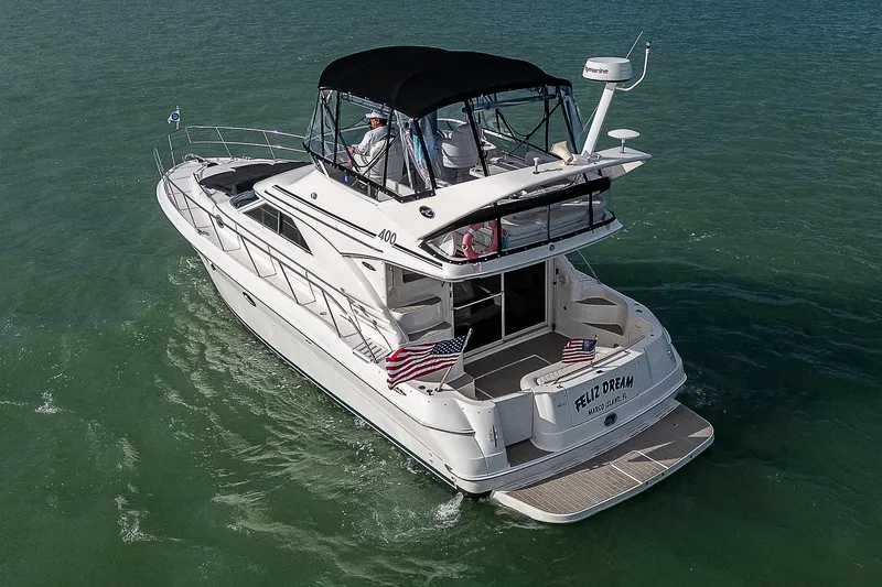 Feliz Dream Yacht Photos Pics 2001 Sea Ray 400 Sedan Bridge yacht cruising on open water.