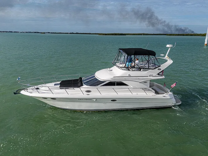 Feliz Dream Yacht Photos Pics 2001 Sea Ray 400 Sedan Bridge yacht cruising on calm waters.
