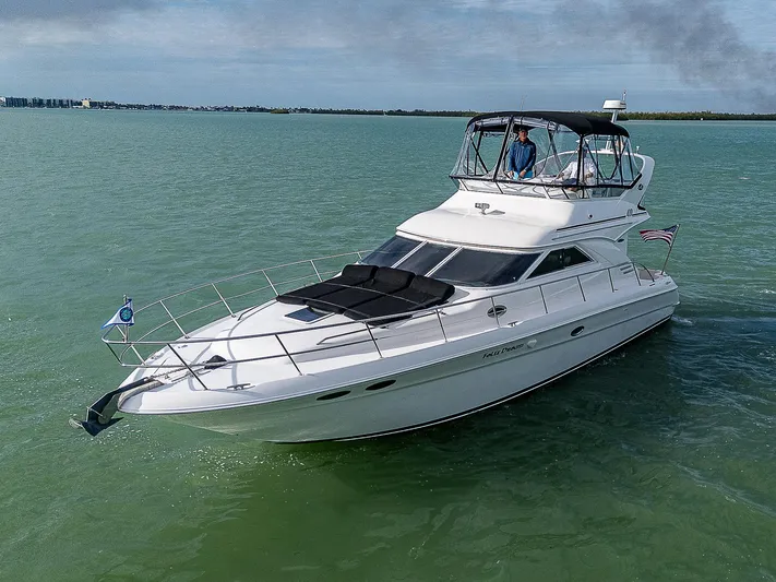Feliz Dream Yacht Photos Pics 2001 Sea Ray 400 Sedan Bridge yacht cruising on calm waters.
