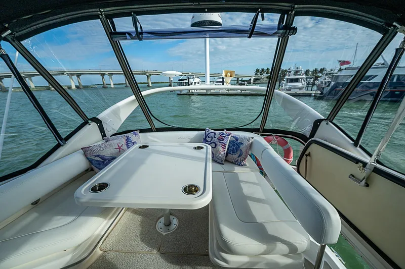 Feliz Dream Yacht Photos Pics Interior view of 2001 Sea Ray 400 Sedan Bridge yacht with seating and table.