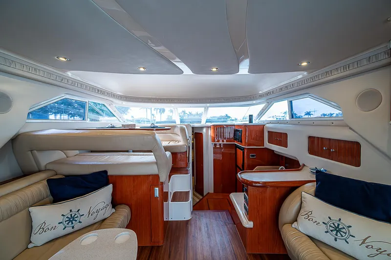 Feliz Dream Yacht Photos Pics Interior of 2001 Sea Ray 400 Sedan Bridge yacht, featuring luxurious seating and wood finishes.