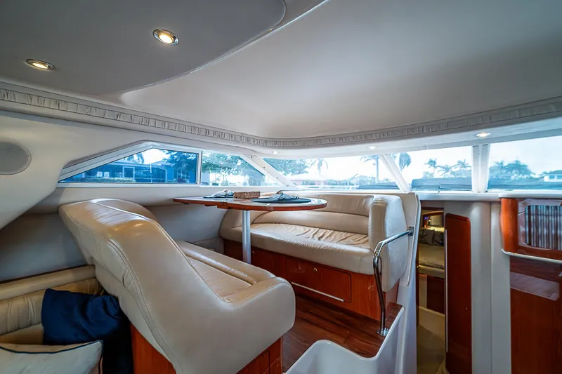Feliz Dream Yacht Photos Pics Interior of 2001 Sea Ray 400 Sedan Bridge yacht with plush seating and dining area.