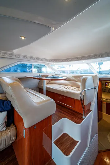 Feliz Dream Yacht Photos Pics Interior of 2001 Sea Ray 400 Sedan Bridge yacht with plush seating and wooden accents.