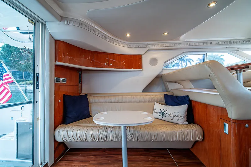 Feliz Dream Yacht Photos Pics Interior of 2001 Sea Ray 400 Sedan Bridge yacht with cozy seating and table.