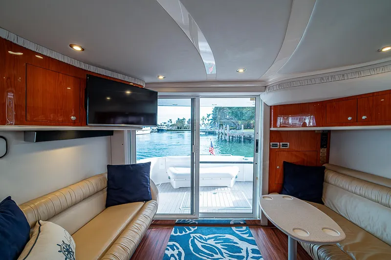 Feliz Dream Yacht Photos Pics Interior of 2001 Sea Ray 400 Sedan Bridge yacht with elegant seating and waterfront view.