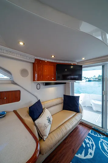 Feliz Dream Yacht Photos Pics Interior of 2001 Sea Ray 400 Sedan Bridge yacht with sofa, TV, and waterfront view.