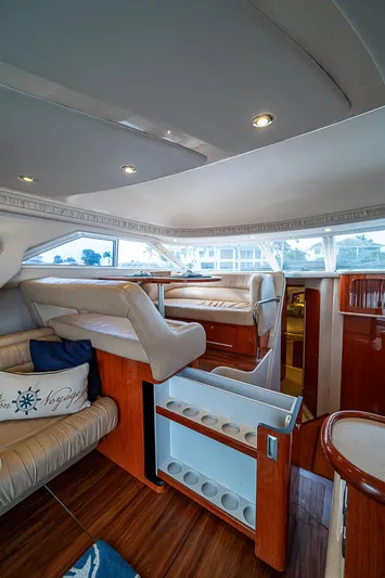 Feliz Dream Yacht Photos Pics Interior of 2001 Sea Ray 400 Sedan Bridge, featuring luxurious seating and elegant wood finishes.