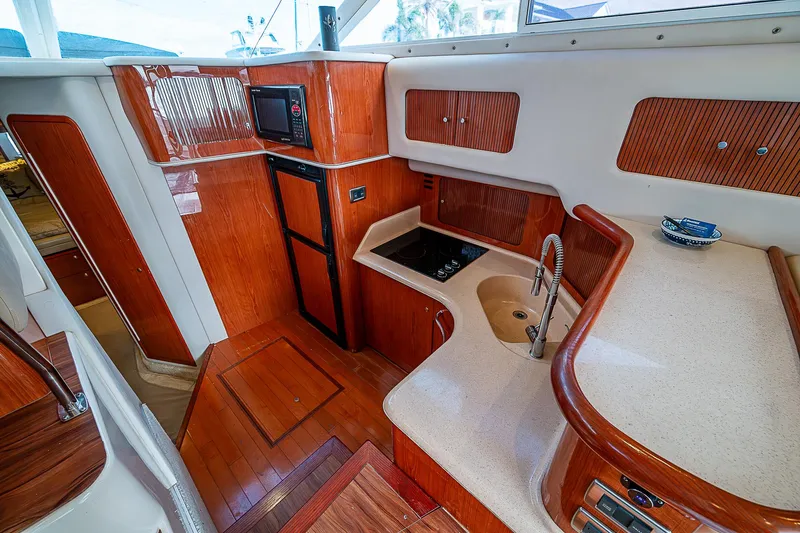 Feliz Dream Yacht Photos Pics Interior of 2001 Sea Ray 400 Sedan Bridge yacht with modern kitchen amenities.