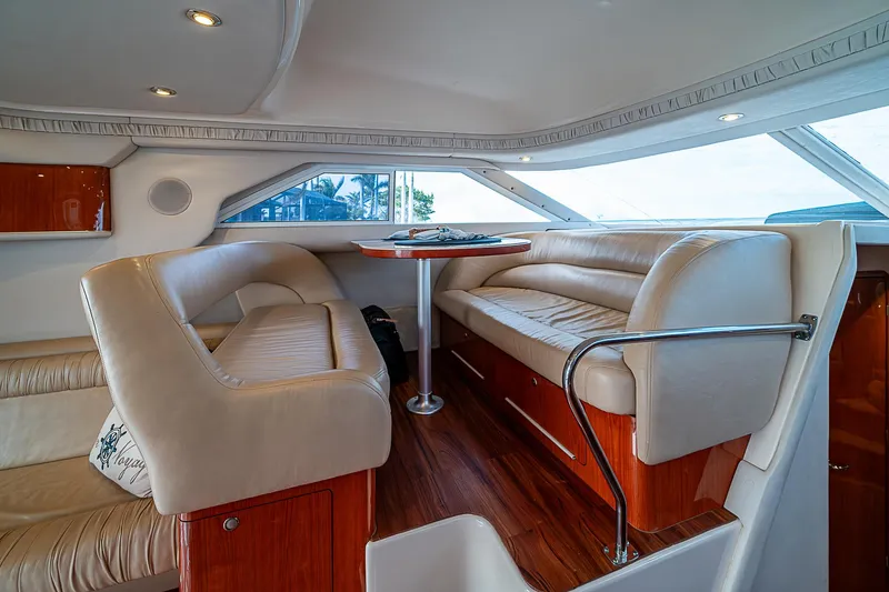 Feliz Dream Yacht Photos Pics Interior of 2001 Sea Ray 400 Sedan Bridge with plush seating and wooden accents.