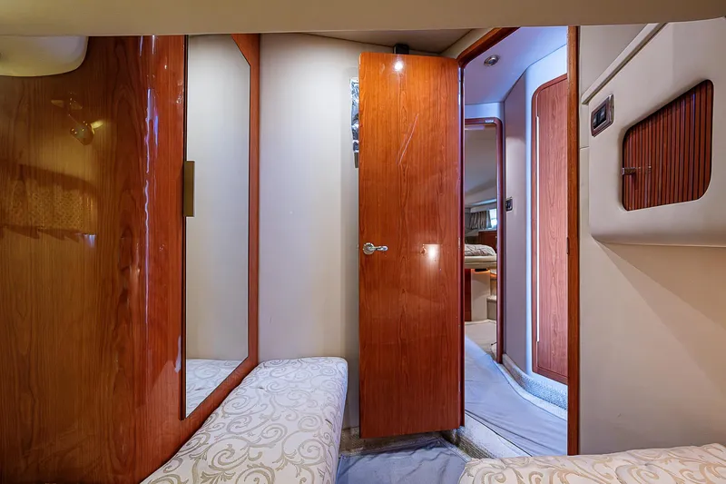 Feliz Dream Yacht Photos Pics Interior of 2001 Sea Ray 400 Sedan Bridge, featuring wood paneling and cozy cabin space.