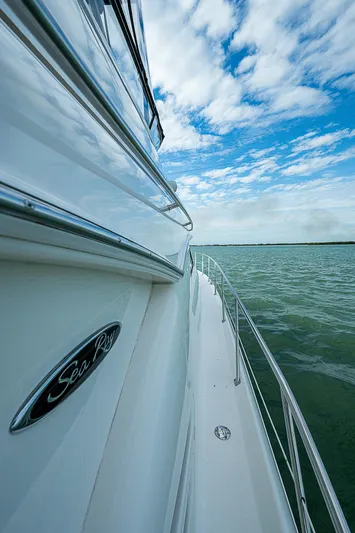 Feliz Dream Yacht Photos Pics Side view of 2001 Sea Ray 400 Sedan Bridge yacht on open water under blue sky.