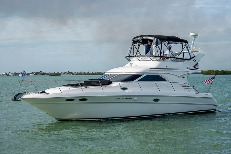 Feliz Dream Yacht Photos Pics 2001 Sea Ray 400 Sedan Bridge yacht cruising on calm waters.