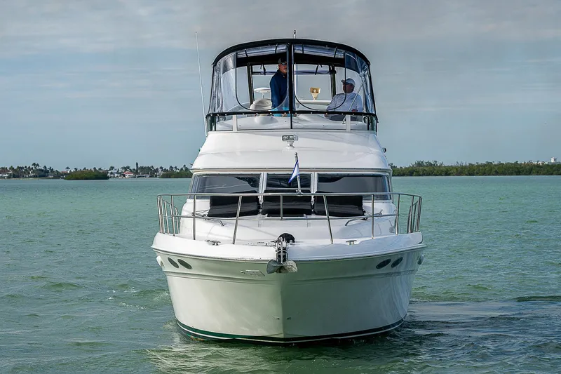 Feliz Dream Yacht Photos Pics 2001 Sea Ray 400 Sedan Bridge yacht on calm water, front view.