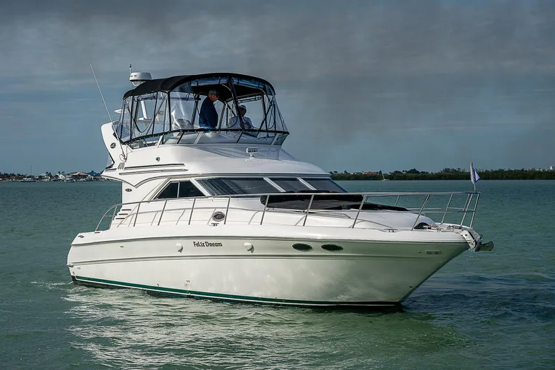 Feliz Dream Yacht Photos Pics 2001 Sea Ray 400 Sedan Bridge yacht cruising on calm waters.