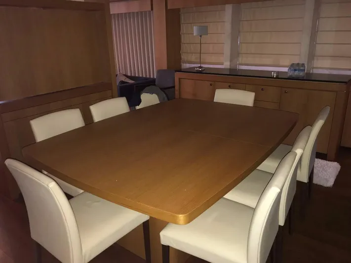 Melissa Yacht Photos Pics Dining area on a 2011 Sunseeker 34 Metre Yacht with wooden table and white chairs.