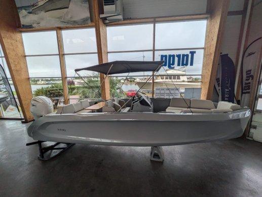 2023 Rand Source 22 boat displayed indoors with canopy and seating.