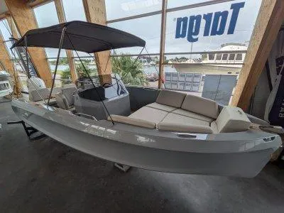 2023 Rand Source 22 boat with canopy and seating, displayed indoors.