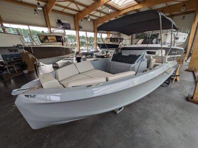 2023 Rand Source 22 boat in showroom, featuring sleek design and spacious seating.