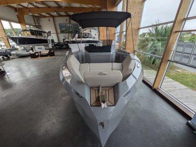 2023 Rand Source 22 boat in showroom, featuring sleek design and spacious seating.