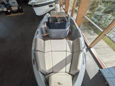 2023 Rand Source 22 boat interior with beige seating, docked indoors.