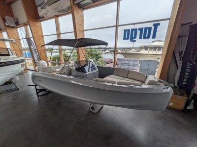 2023 Rand Source 22 boat displayed indoors with canopy and seating.