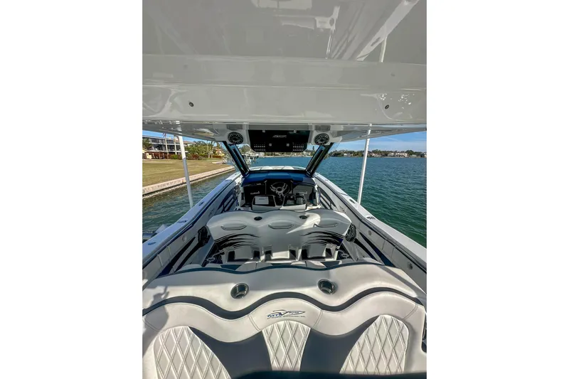  Yacht Photos Pics 2024 MTI V42 boat interior with luxurious seating and advanced dashboard on a sunny day.