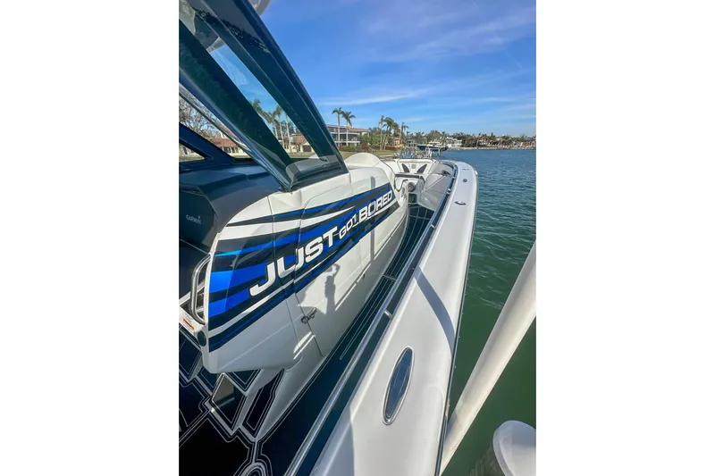  Yacht Photos Pics 2024 MTI V42 boat docked, featuring sleek design and "Just Bored" graphics.