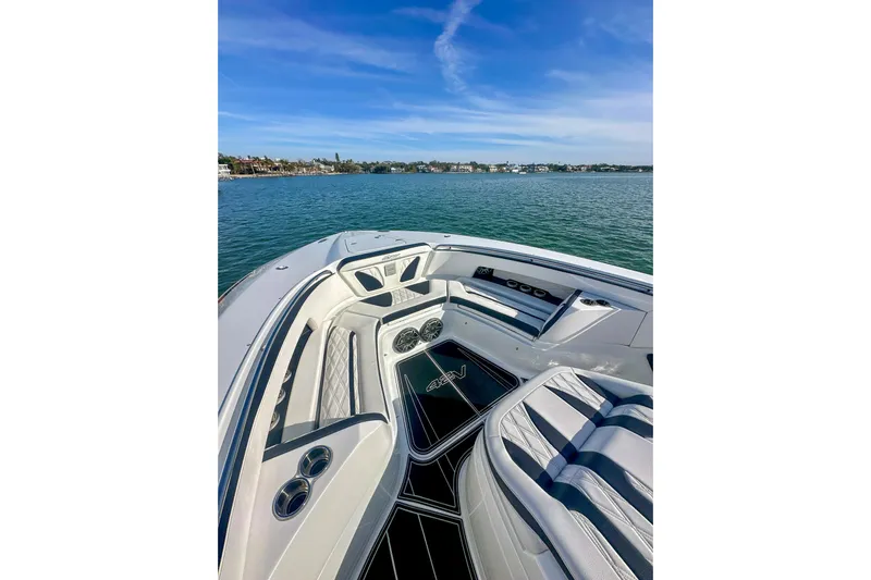  Yacht Photos Pics Luxurious 2024 MTI V42 boat interior with elegant seating on calm waters.