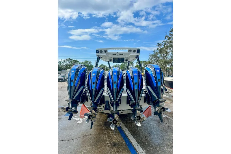  Yacht Photos Pics Four powerful outboard motors on a 2024 MTI V42 boat under a clear blue sky.