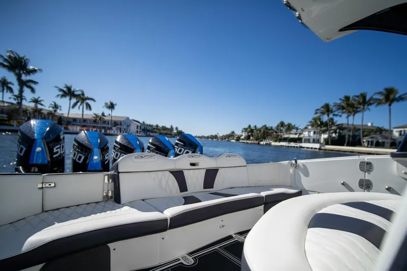  Yacht Photos Pics 2024 MTI V42 boat with powerful engines, luxurious seating, and scenic waterfront view.