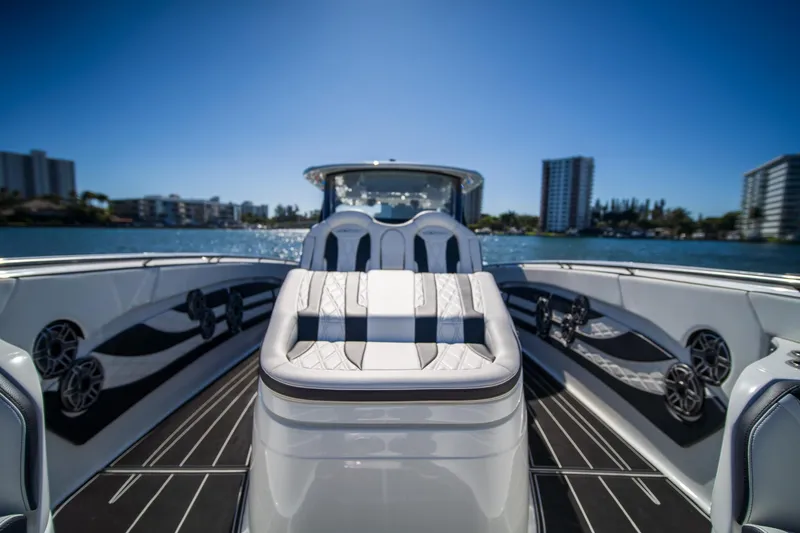  Yacht Photos Pics 2024 MTI V42 luxury boat interior with sleek seating and waterfront view.