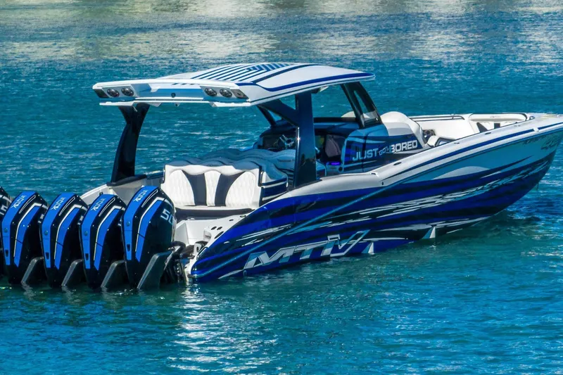  Yacht Photos Pics 2024 MTI V42 boat with multiple engines on clear blue water.
