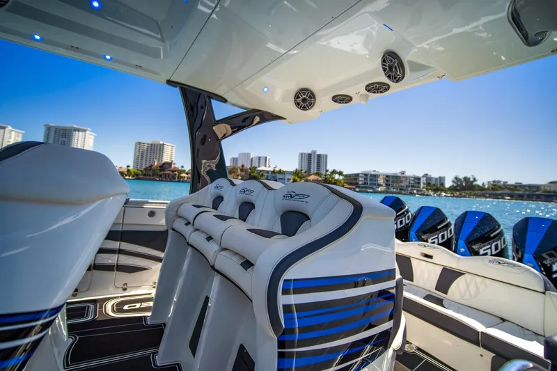  Yacht Photos Pics Luxury MTI V42 boat interior with modern seating, overlooking waterfront cityscape, 2024 model.
