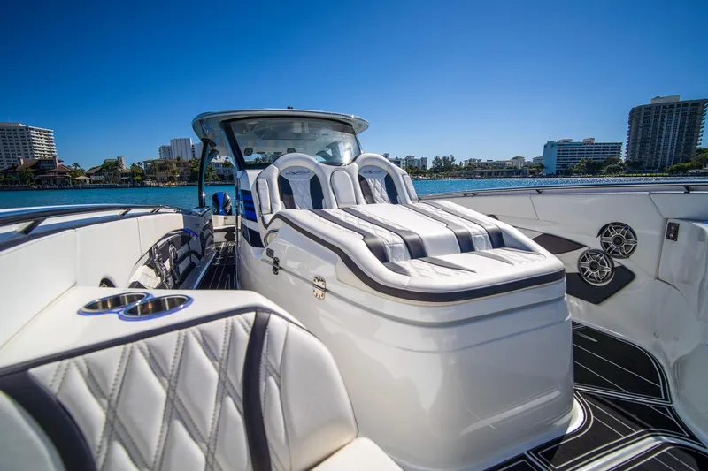  Yacht Photos Pics Luxurious 2024 MTI V42 boat interior with plush seating and waterfront view.