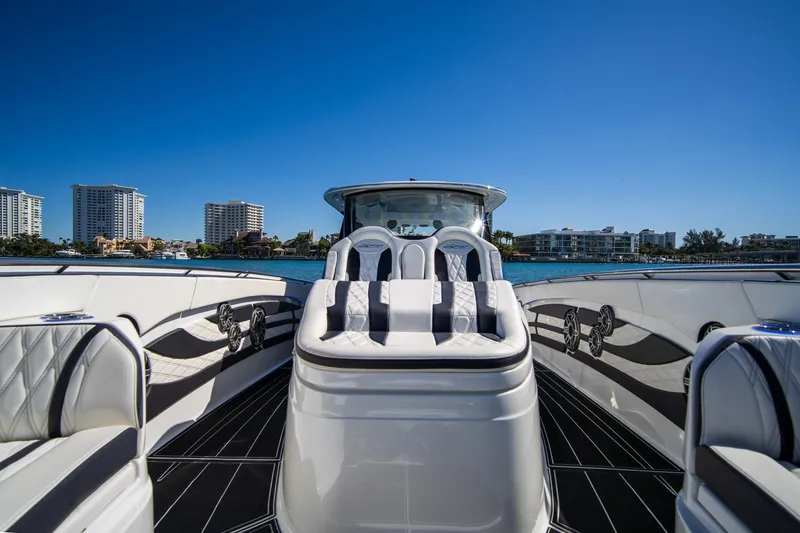  Yacht Photos Pics Luxurious 2024 MTI V42 yacht interior with plush seating and waterfront skyline view.