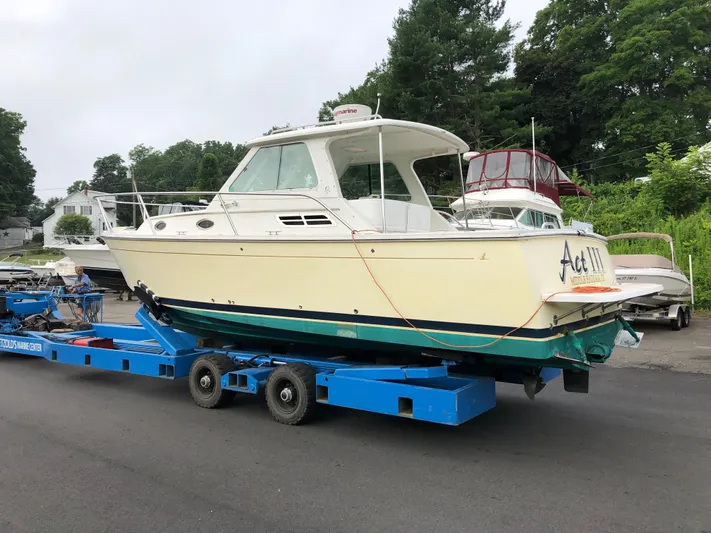 Act III Yacht Photos Pics 2008 Back Cove 29 boat on trailer, parked outdoors, surrounded by trees and other boats.