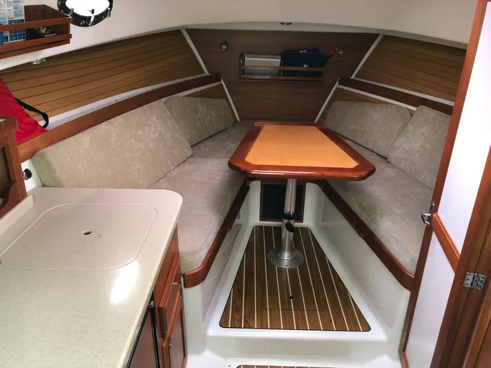 Act III Yacht Photos Pics 2008 Back Cove 29 interior with cozy seating and wooden table.