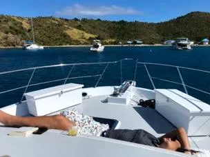 Mcgregor III Yacht Photos Pics Person relaxing on a 2001 Jefferson Marquessa 60 MY yacht in a scenic bay.