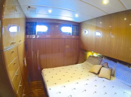 Mcgregor III Yacht Photos Pics Luxurious bedroom interior of 2001 Jefferson Marquessa 60 MY yacht with wood paneling.