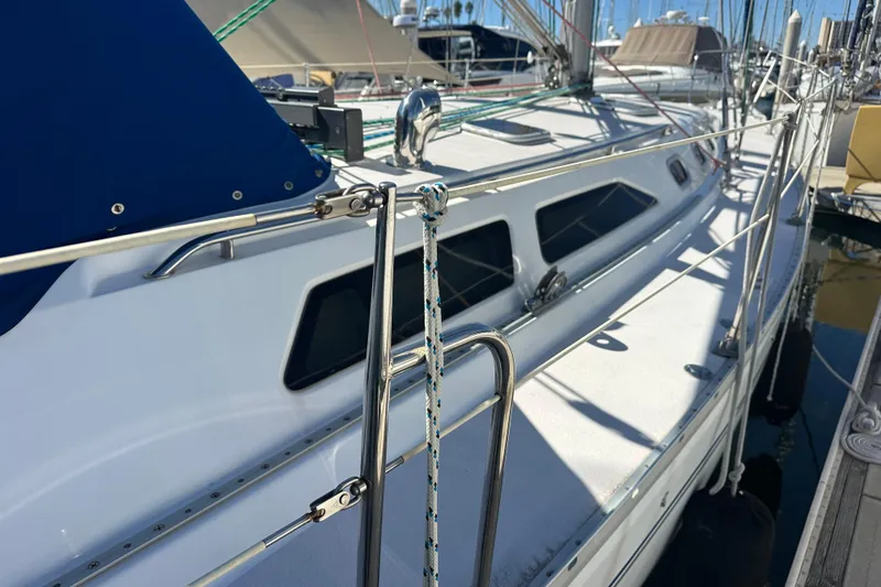 True North Yacht Photos Pics 2003 Catalina 470 sailboat docked, featuring sleek design and stainless steel railings.