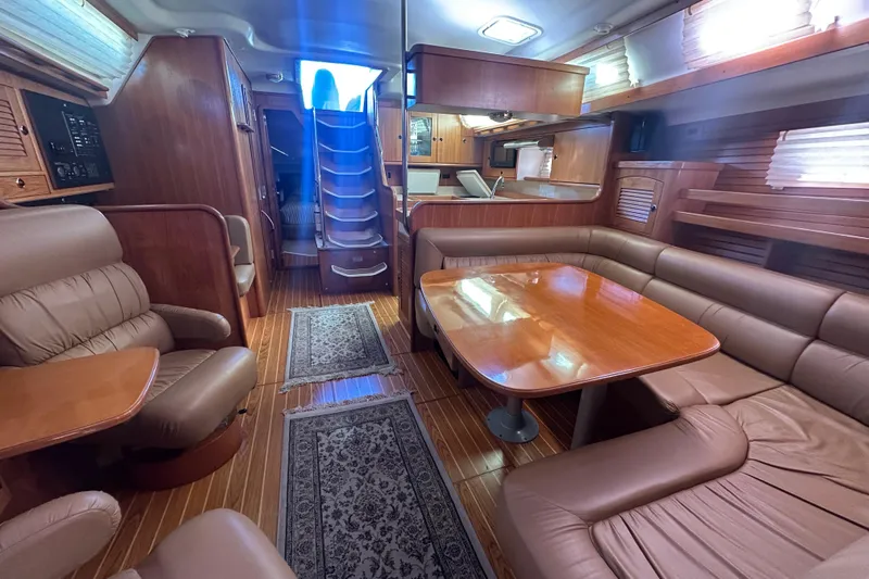 True North Yacht Photos Pics Luxurious interior of a 2003 Catalina 470 yacht with leather seating and wooden finishes.