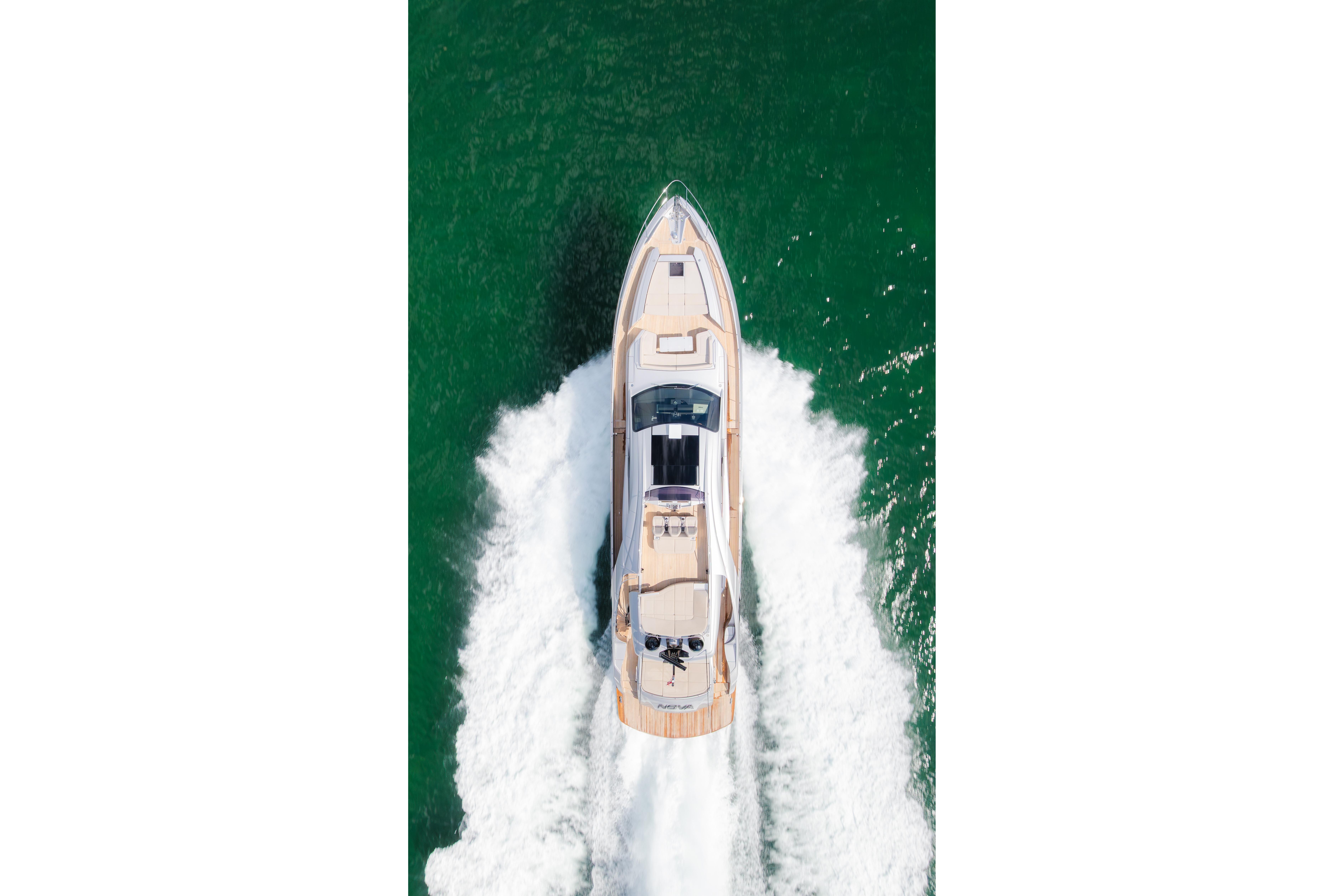 Aerial view of 2021 Pershing 8X yacht cruising on green water.
